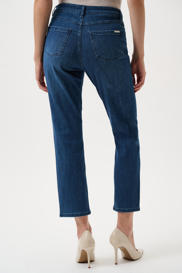 Blue jeans worn by a person on a white background