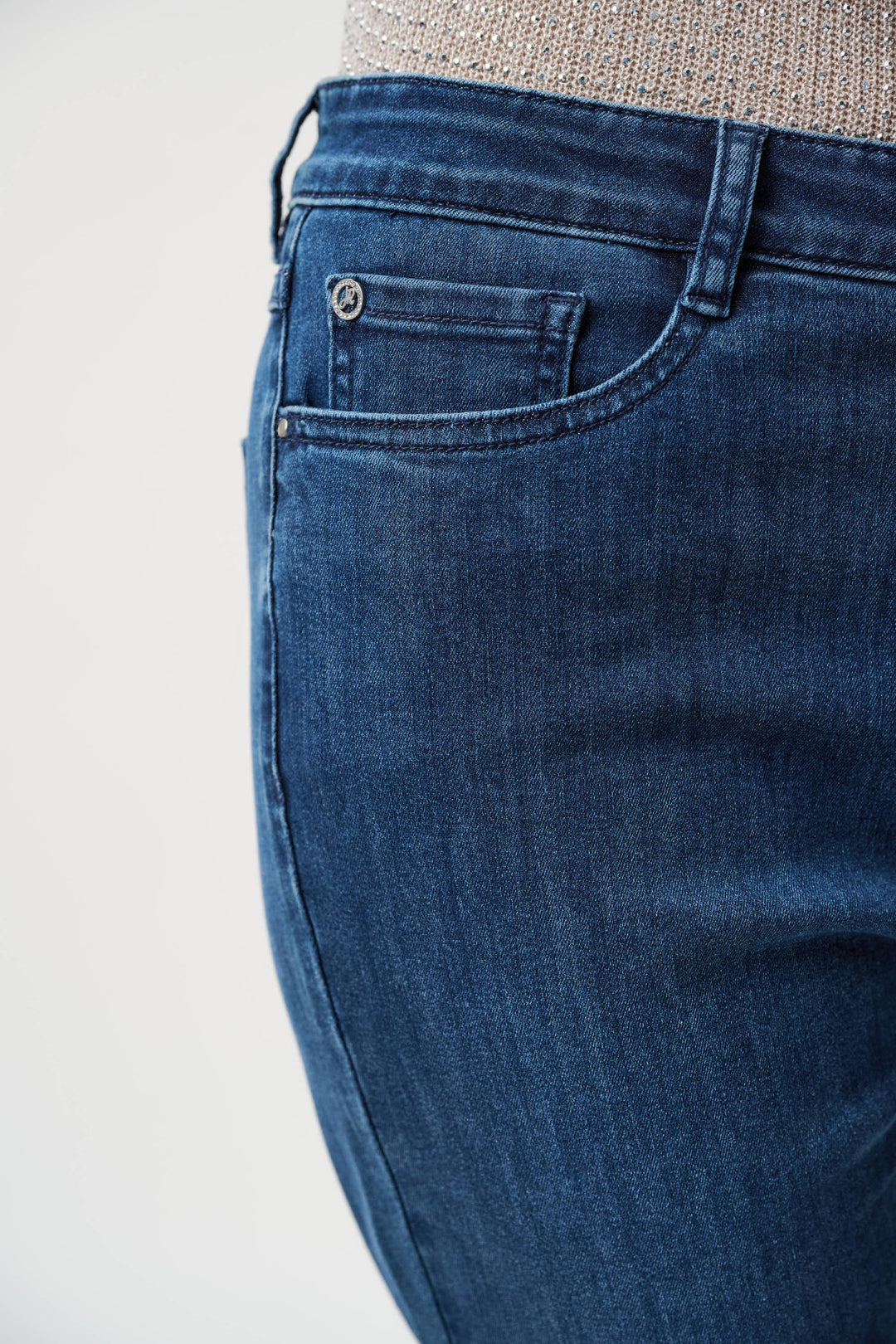 Close-up of blue jeans on a plain background