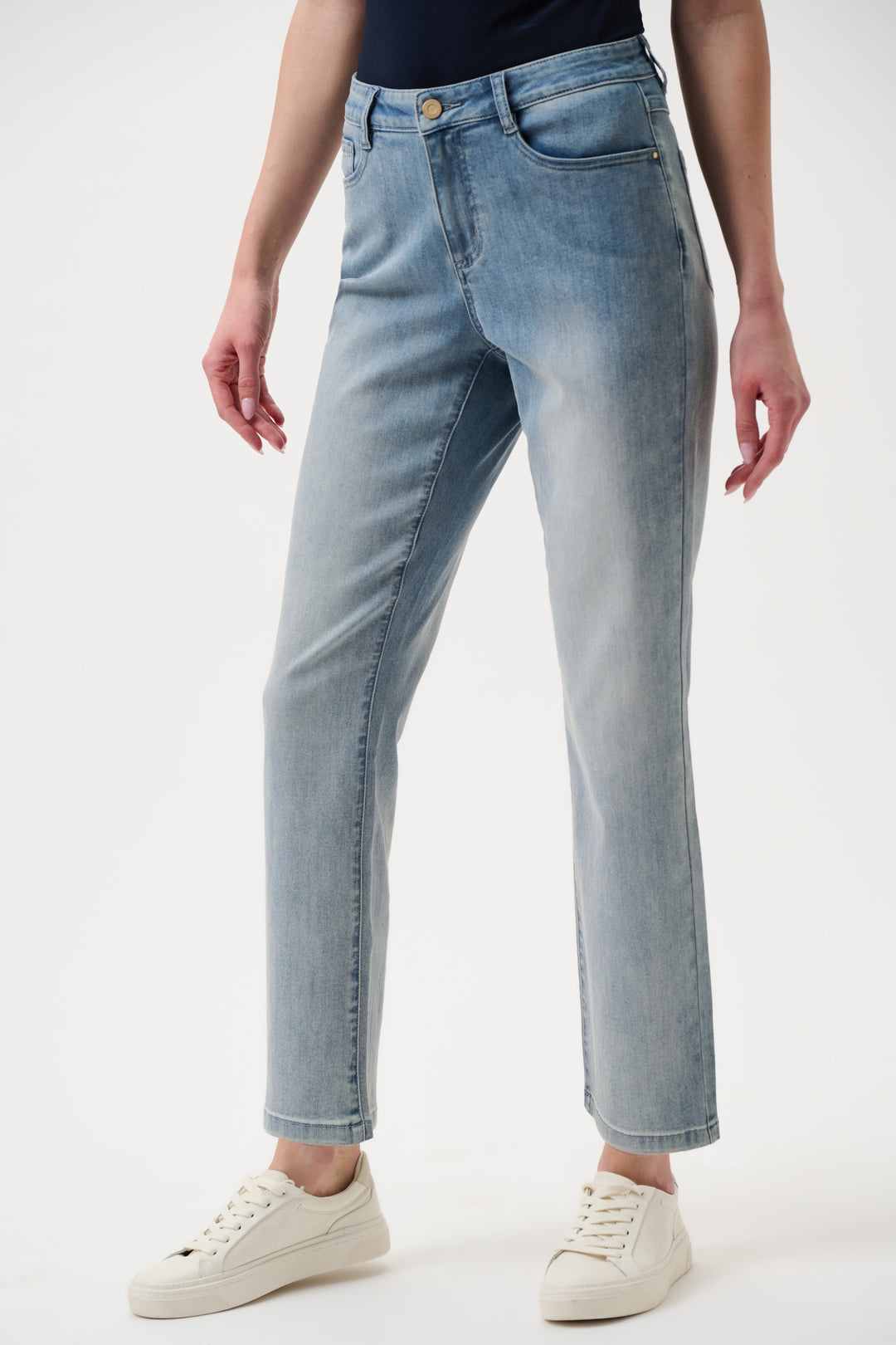 Light blue jeans worn by a person on a white background