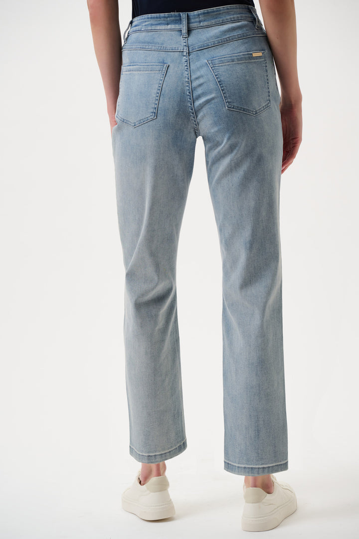 Light blue jeans worn by a person on a white background
