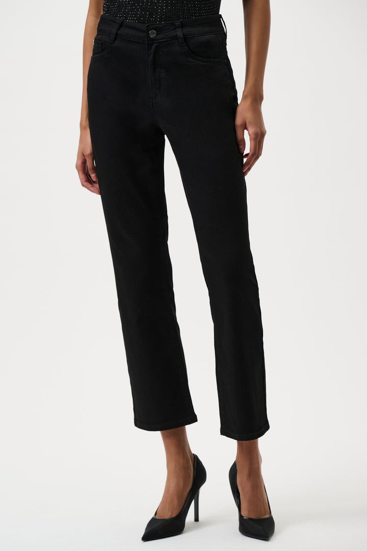 Black jeans worn by a person on a white background