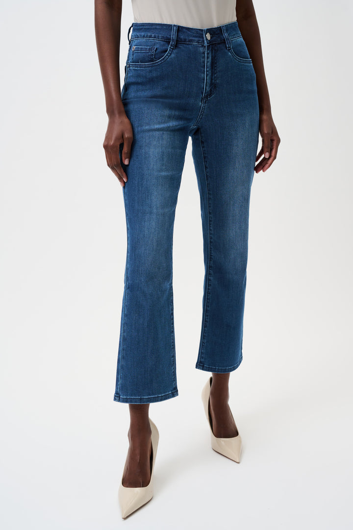 Person wearing blue jeans on a white background
