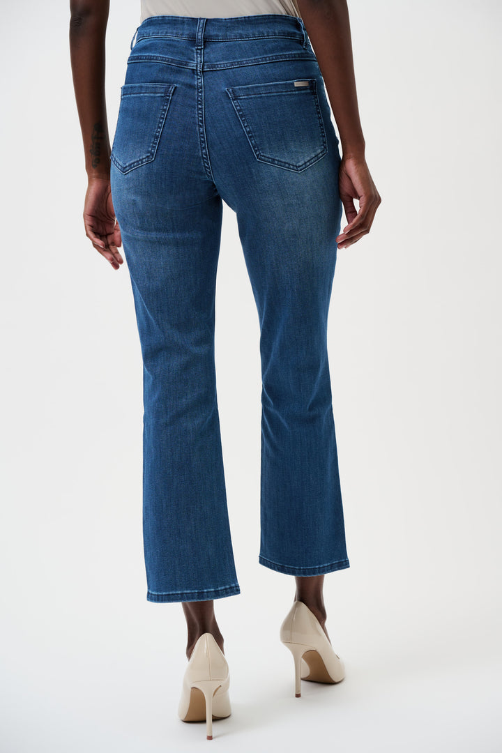 Blue jeans worn by a person on a white background