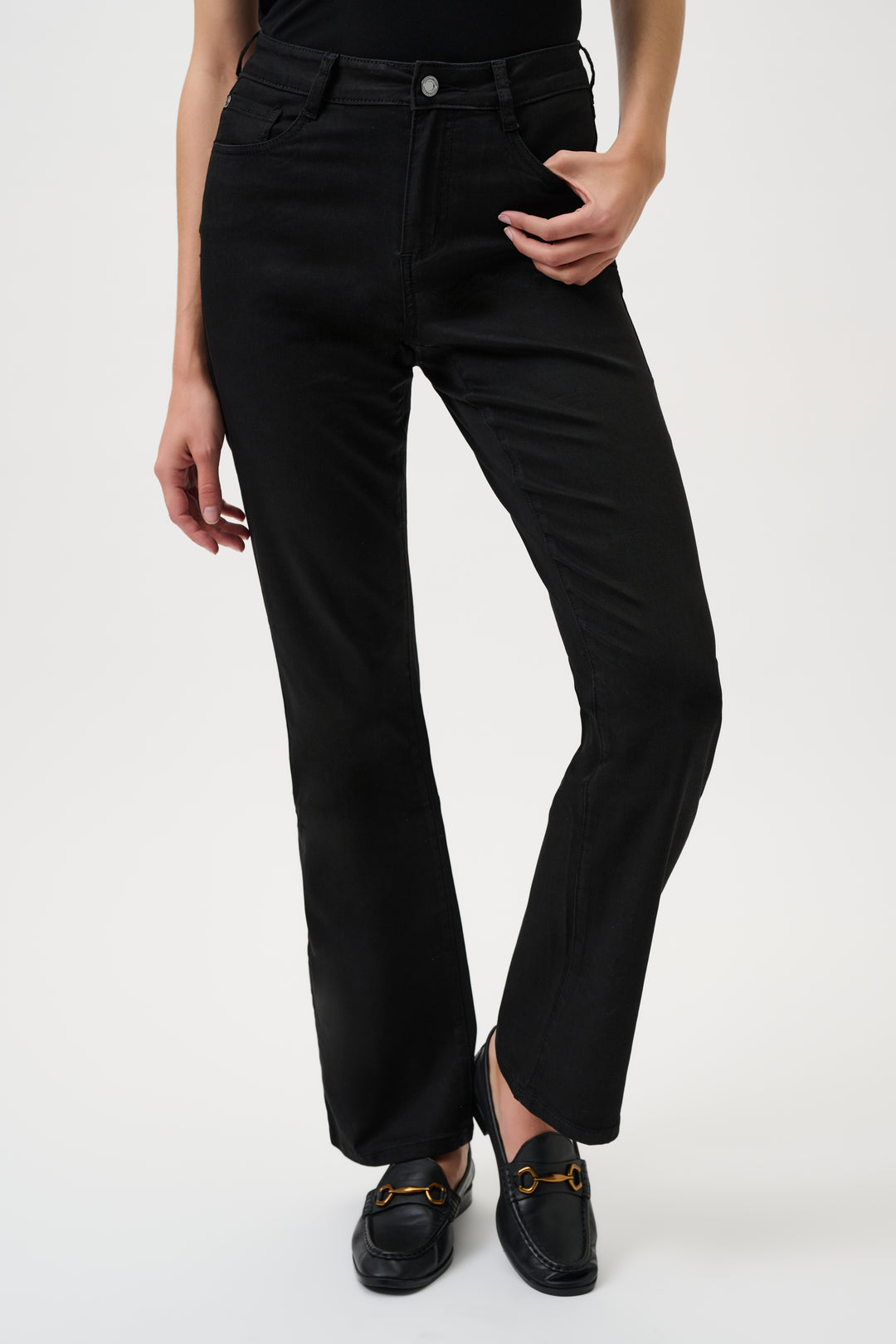 Person wearing black jeans on a white background