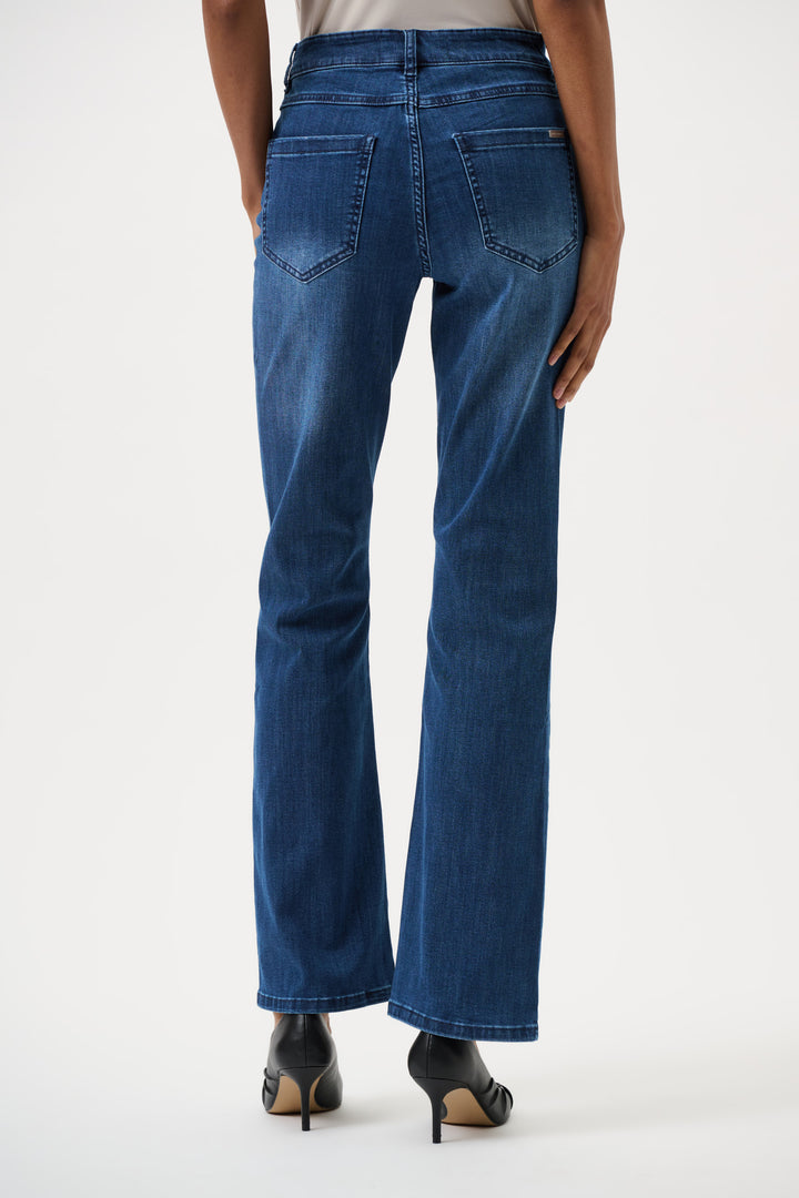 Blue jeans worn by a person on a white background