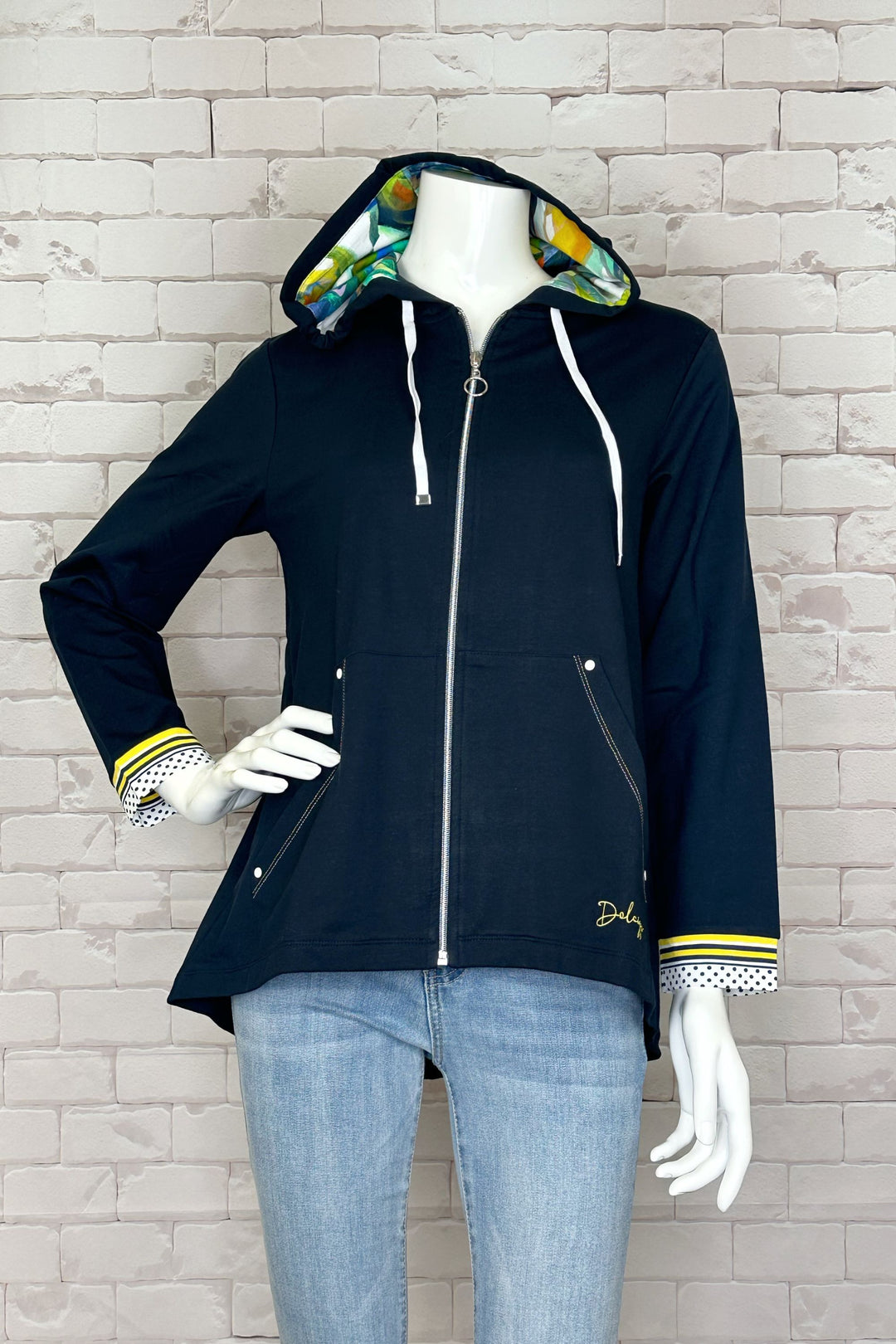 The solid navy colour is complemented by contrast cuffs and a lovely orangerie abstract floral print lined inside the hood. 