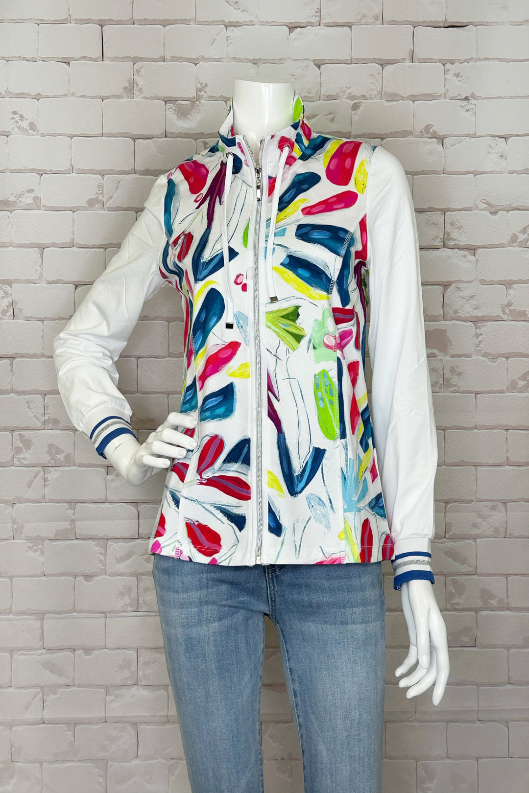 This stimulating Tropical Trace Zip Jacket features contrast sleeves and cuffs, front zipper, two front pockets, a drawstring hood and full length sleeves.