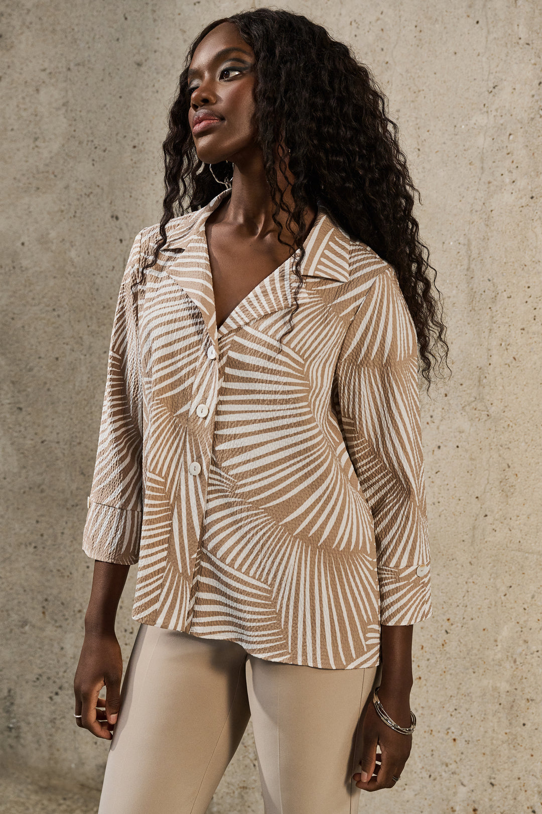 Joseph Ribkoff Spring 2025  the perfect combination of style and comfort. With a flattering fit and classic palm print, this shirt jacket boasts 3/4 cuffed sleeves and standard blouse elements. 