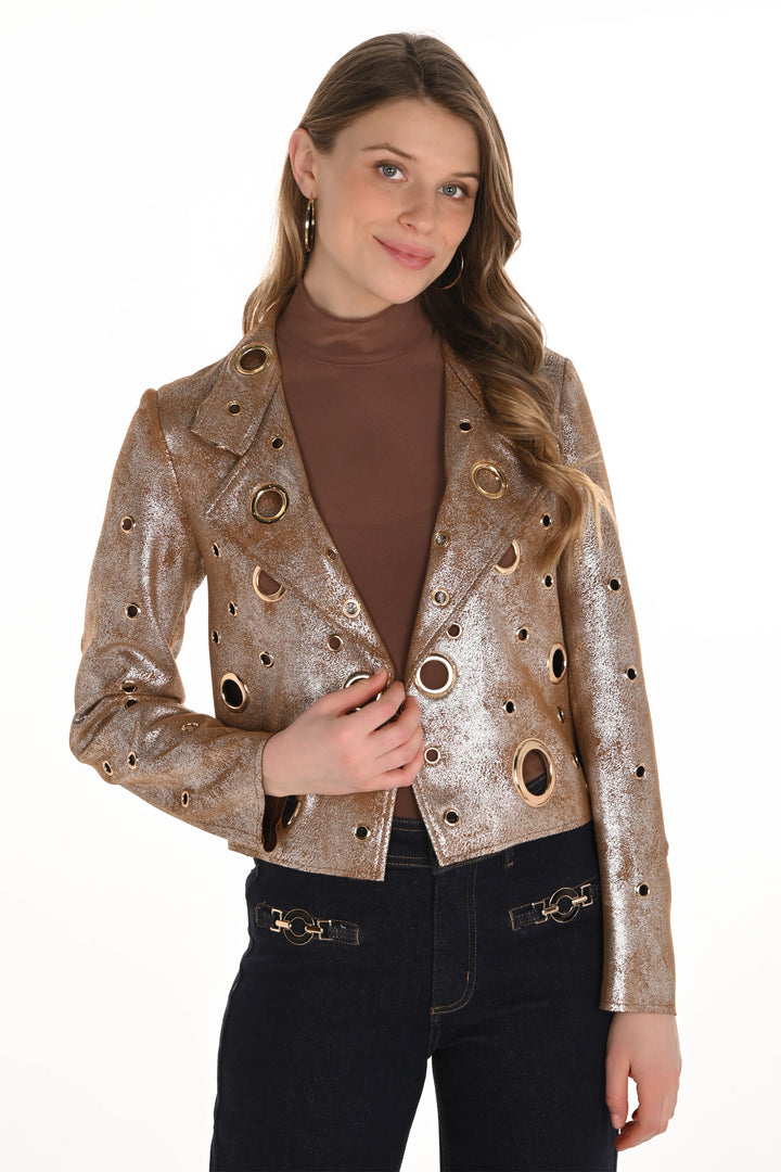 Woman wearing a metallic jacket with circular cutouts on a white background