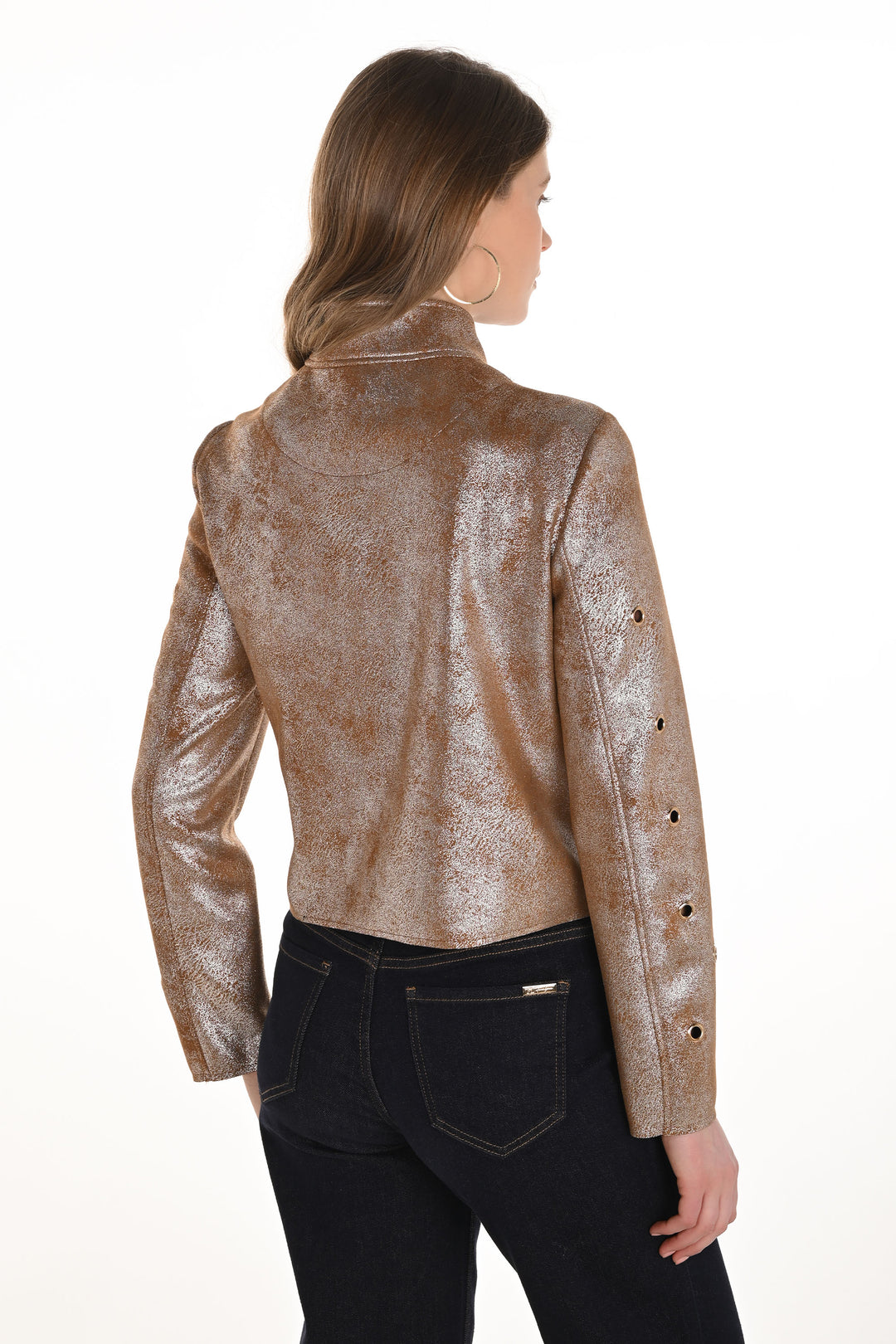 Woman wearing a metallic gold jacket on a white background