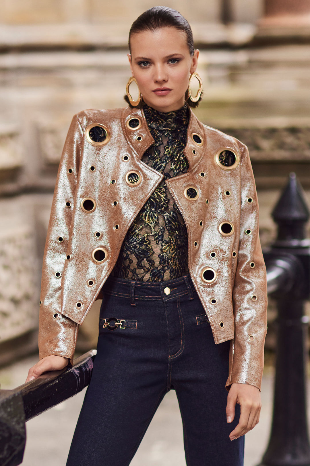 Woman wearing a stylish jacket with cut-out design in an urban setting