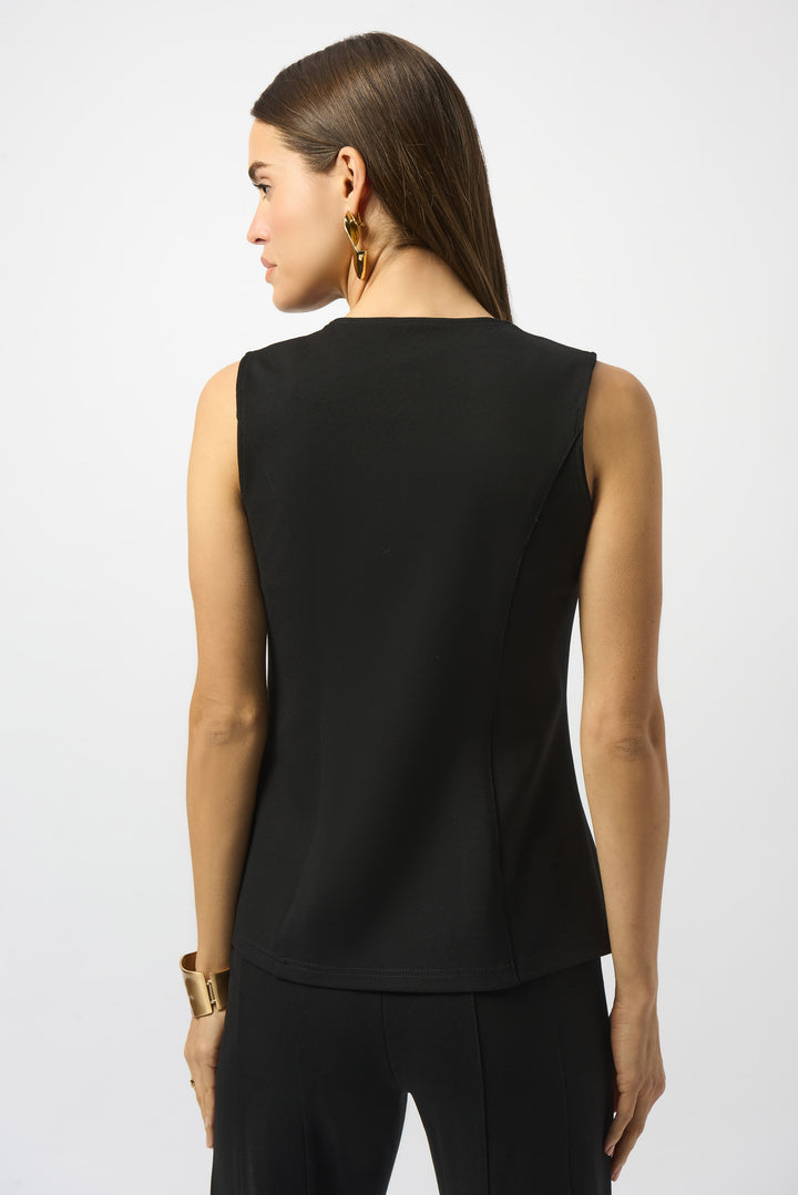 Woman wearing a black sleeveless top on a white background