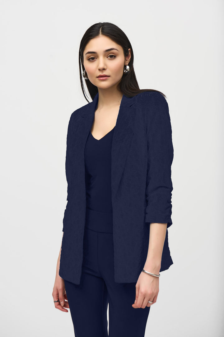 JOSEPH RIBKOFF Spring 2026 
Elevate your wardrobe with this textured rouched sleeve blazer—a seamless blend of timeless elegance and contemporary edge. Featuring a refined notch lapel collar and open front silhouette, it transitions effortlessly from boardroom to weekend. 