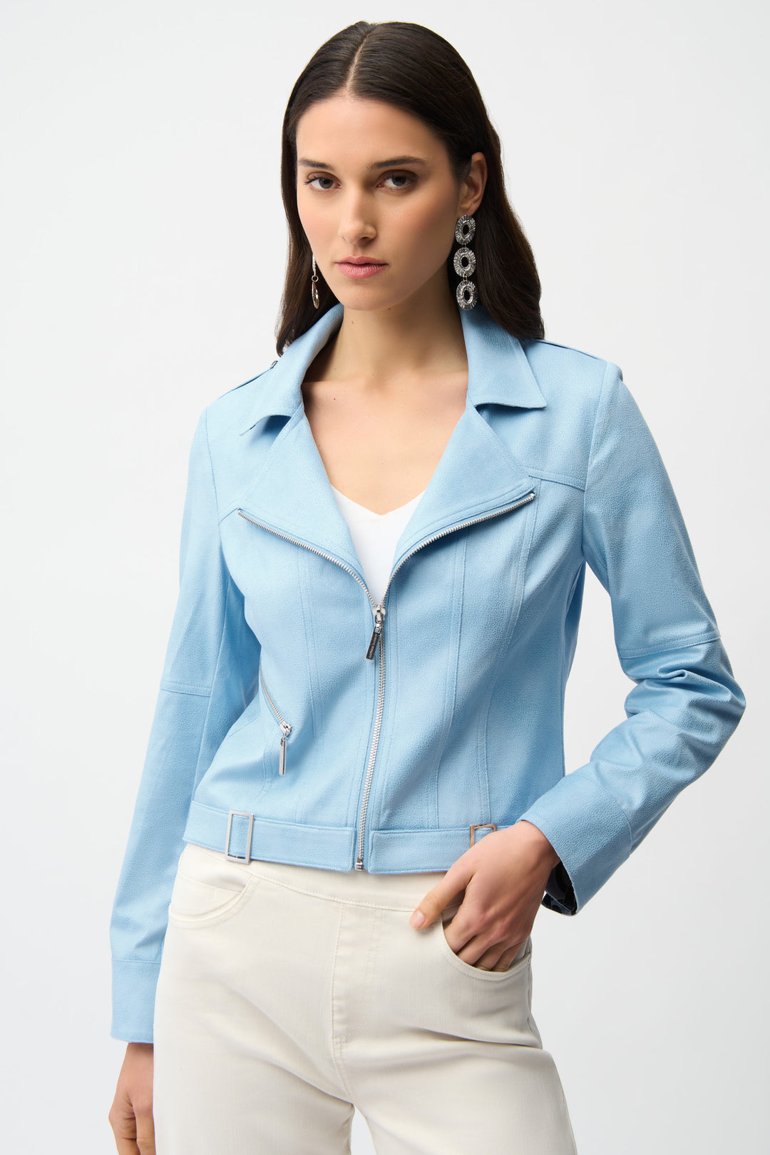 Woman wearing a light blue faux suede jacket on a white background
