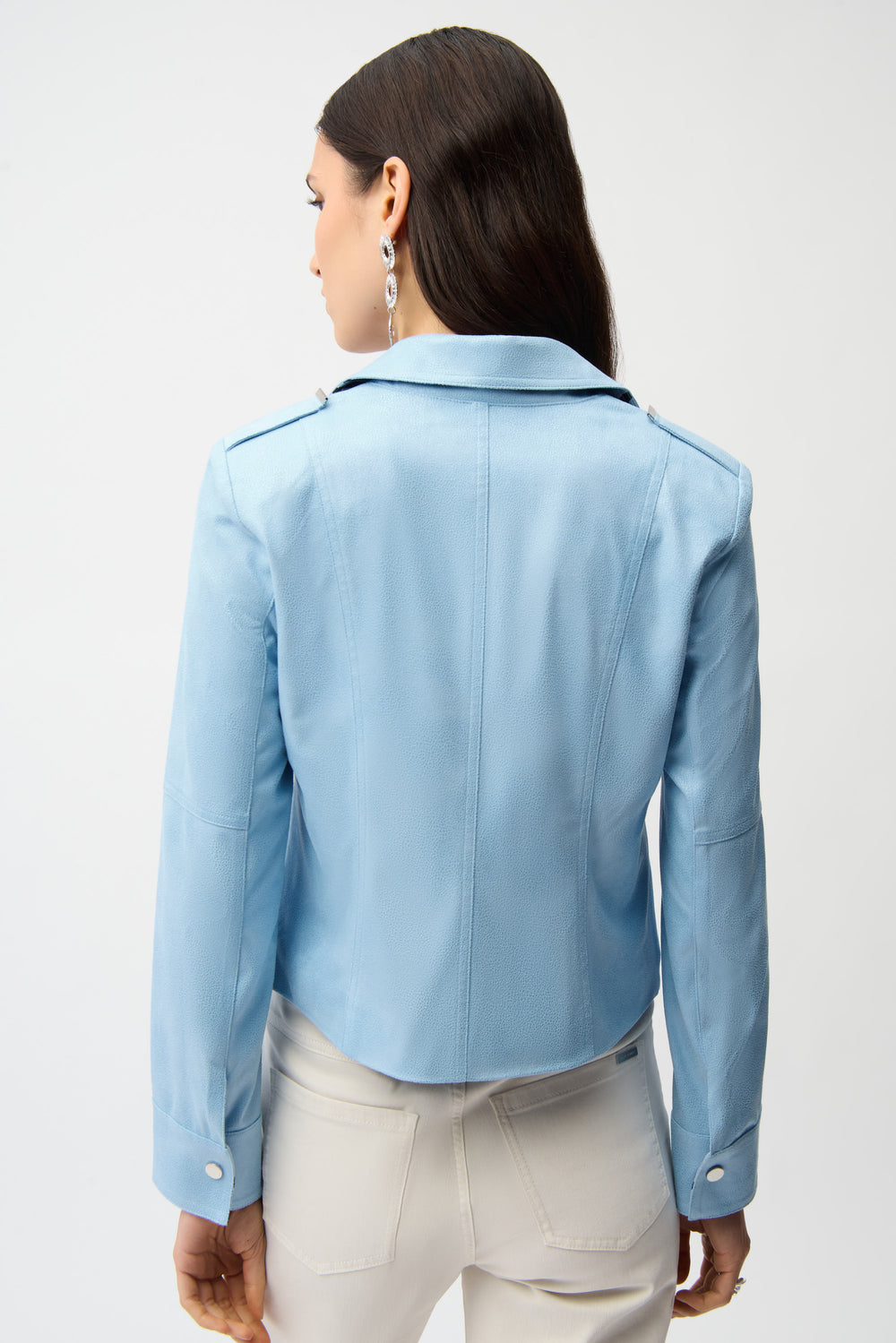 Woman wearing a light blue jacket on a white background