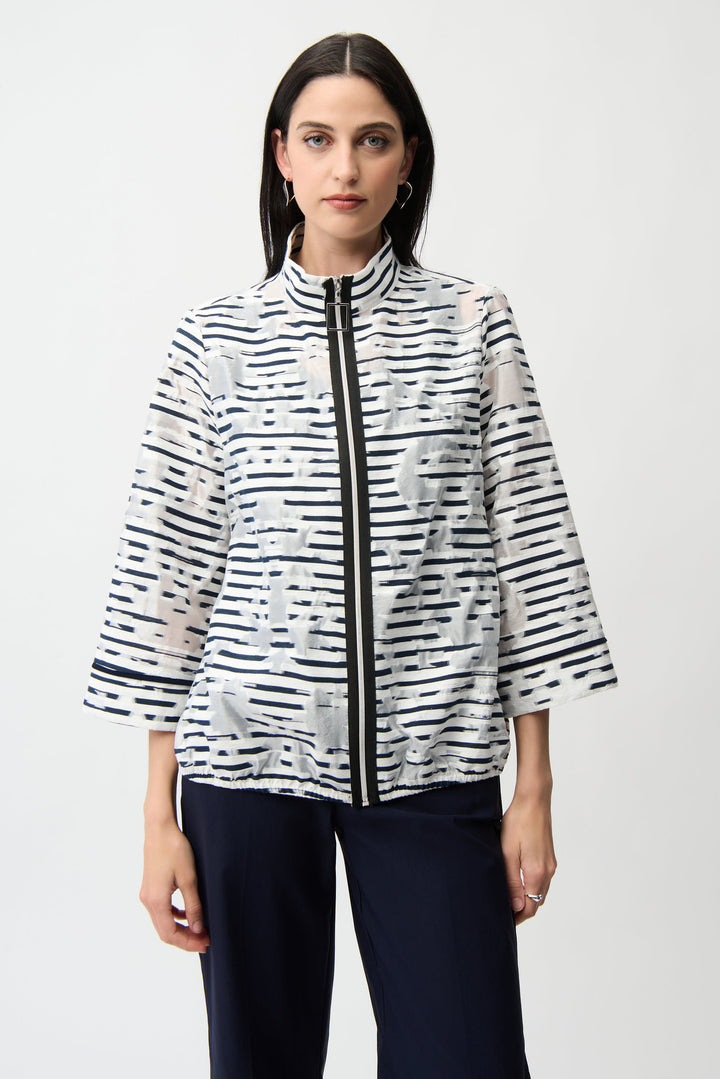Woman wearing a black and white patterned stripe light jacket on a white background