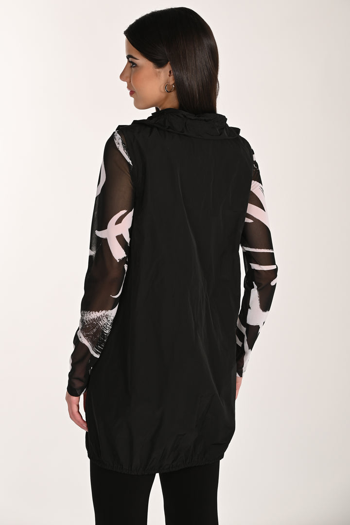 Woman wearing a black long zipper vest with sheer sleeves on a white background