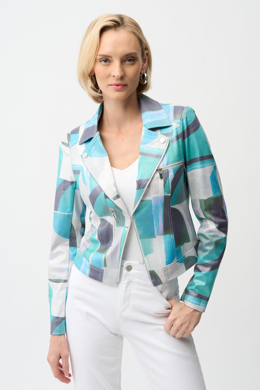 Woman wearing a colorful patterned jean jacket on a white background