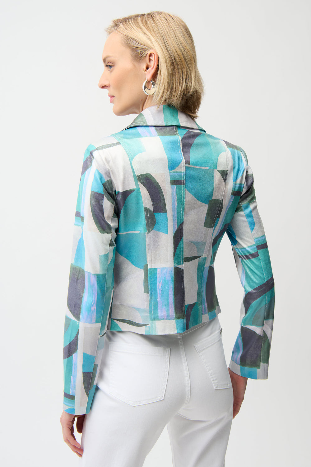 Woman wearing a patterned jacket with a white background