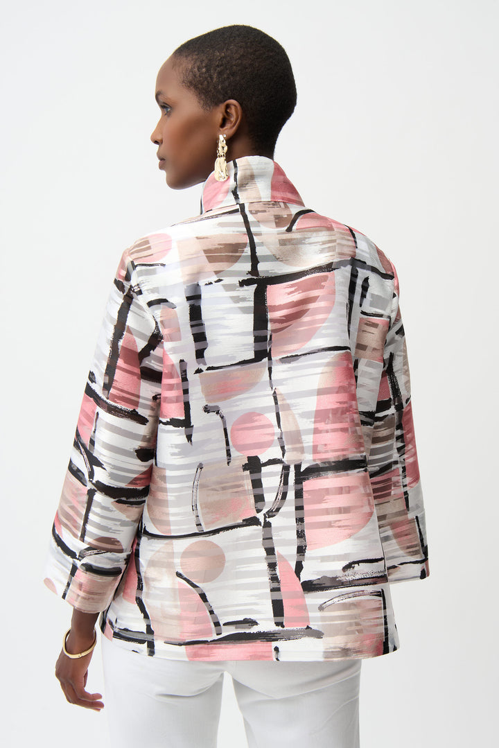 Woman wearing a patterned jacket with abstract designs on a white background