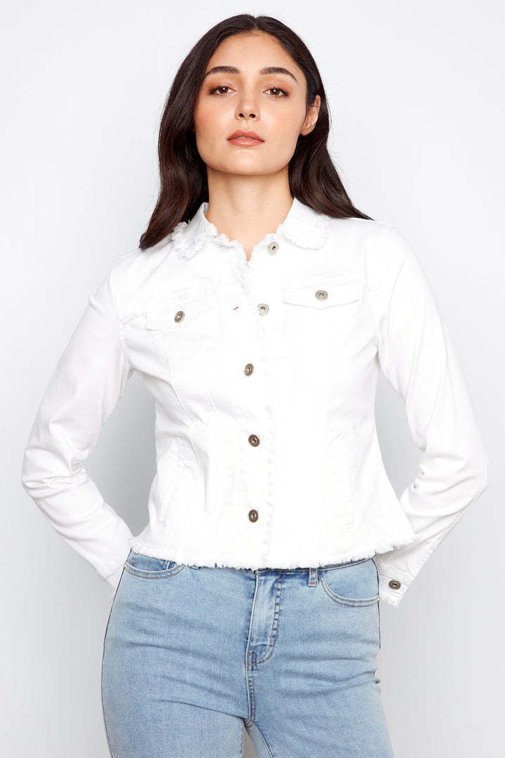 Woman wearing a white shirt with brown buttons and light blue jeans on a white background