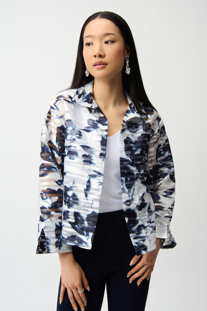 Woman wearing a patterned shirt jacket over a white shirt on a white background