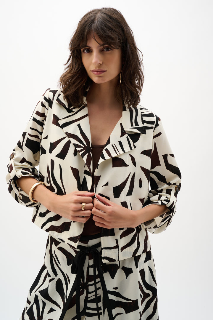 Woman wearing a black and white patterned dress on a white background
