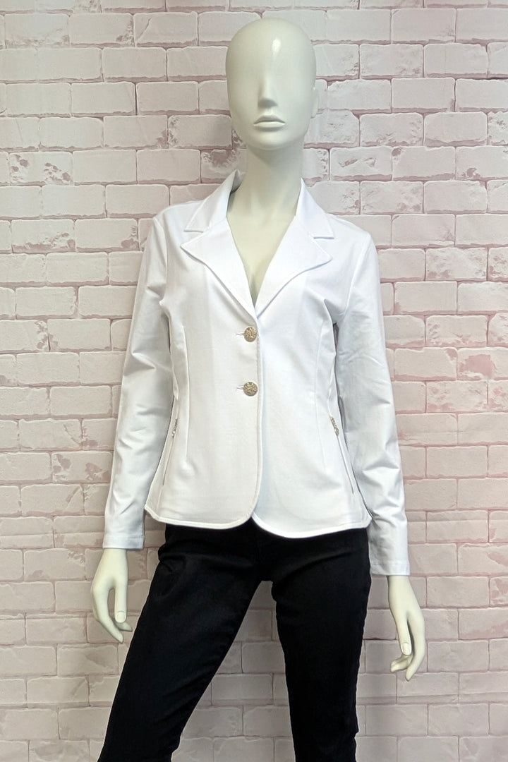 White blazer on a mannequin against a brick wall background