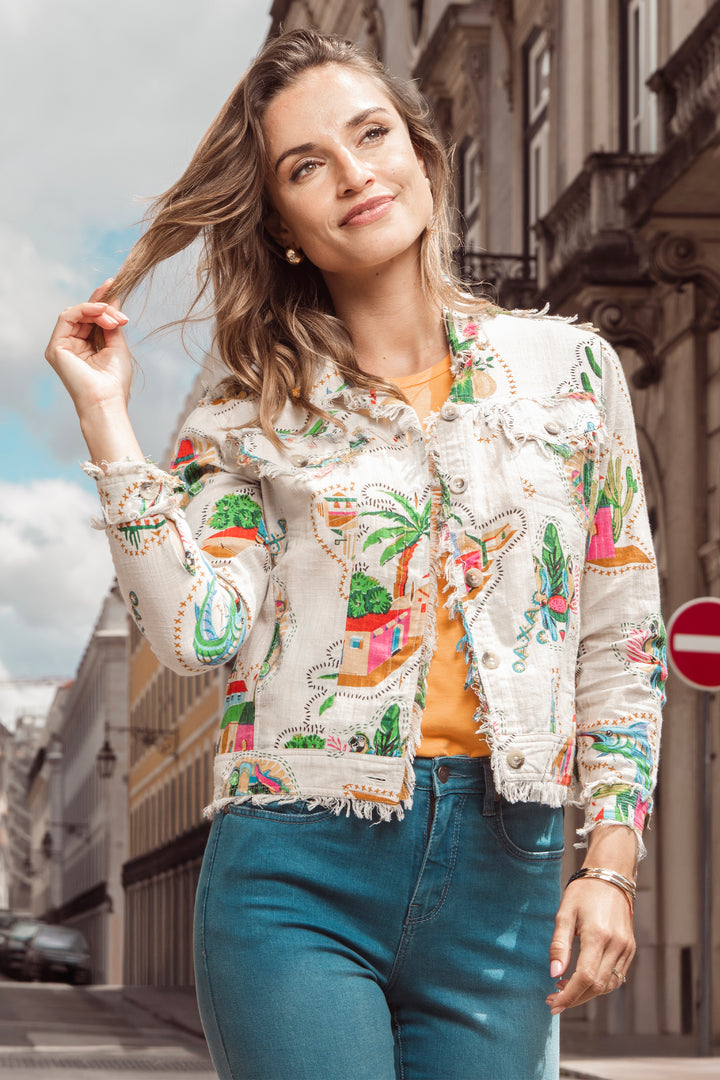 Woman wearing a colorful embroidered light cotton jacket on a city street
