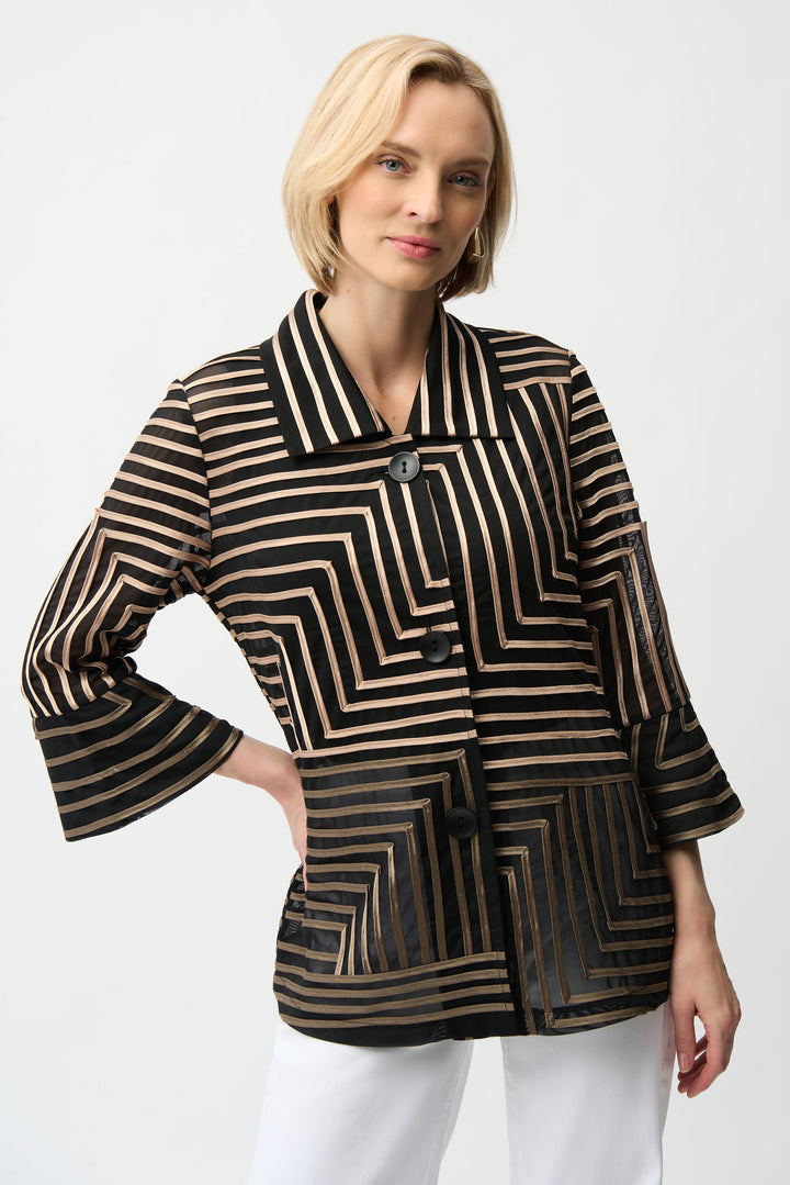 Woman wearing a black and gold striped jacket on a white background