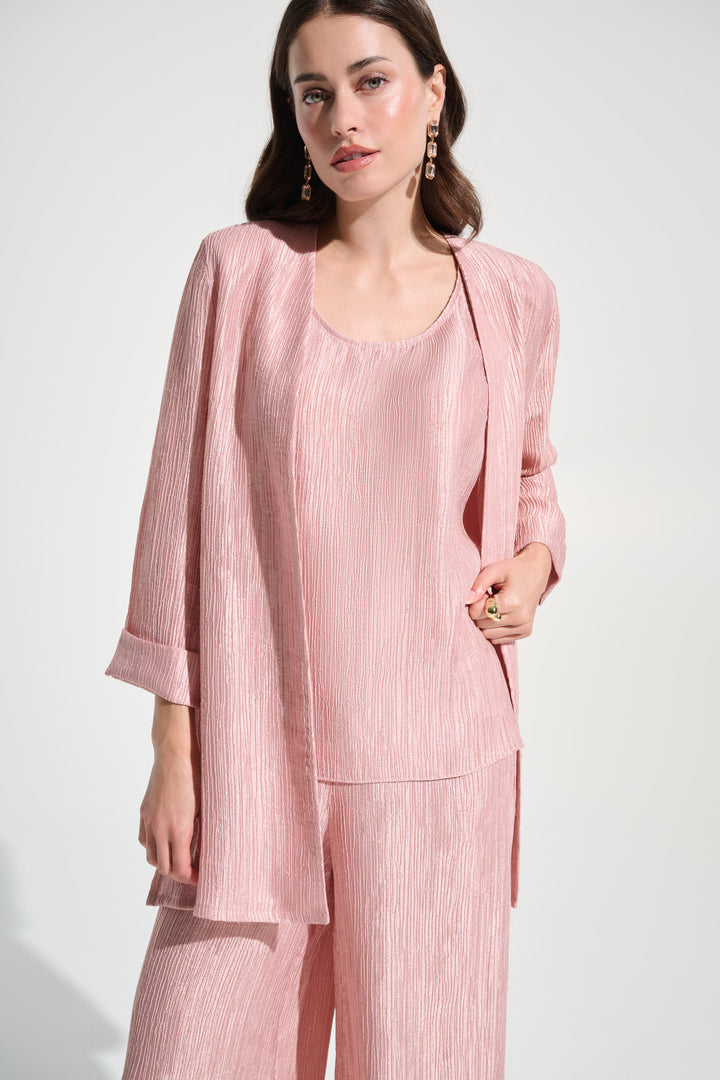 Woman wearing a pink outfit with a jacket on a white background