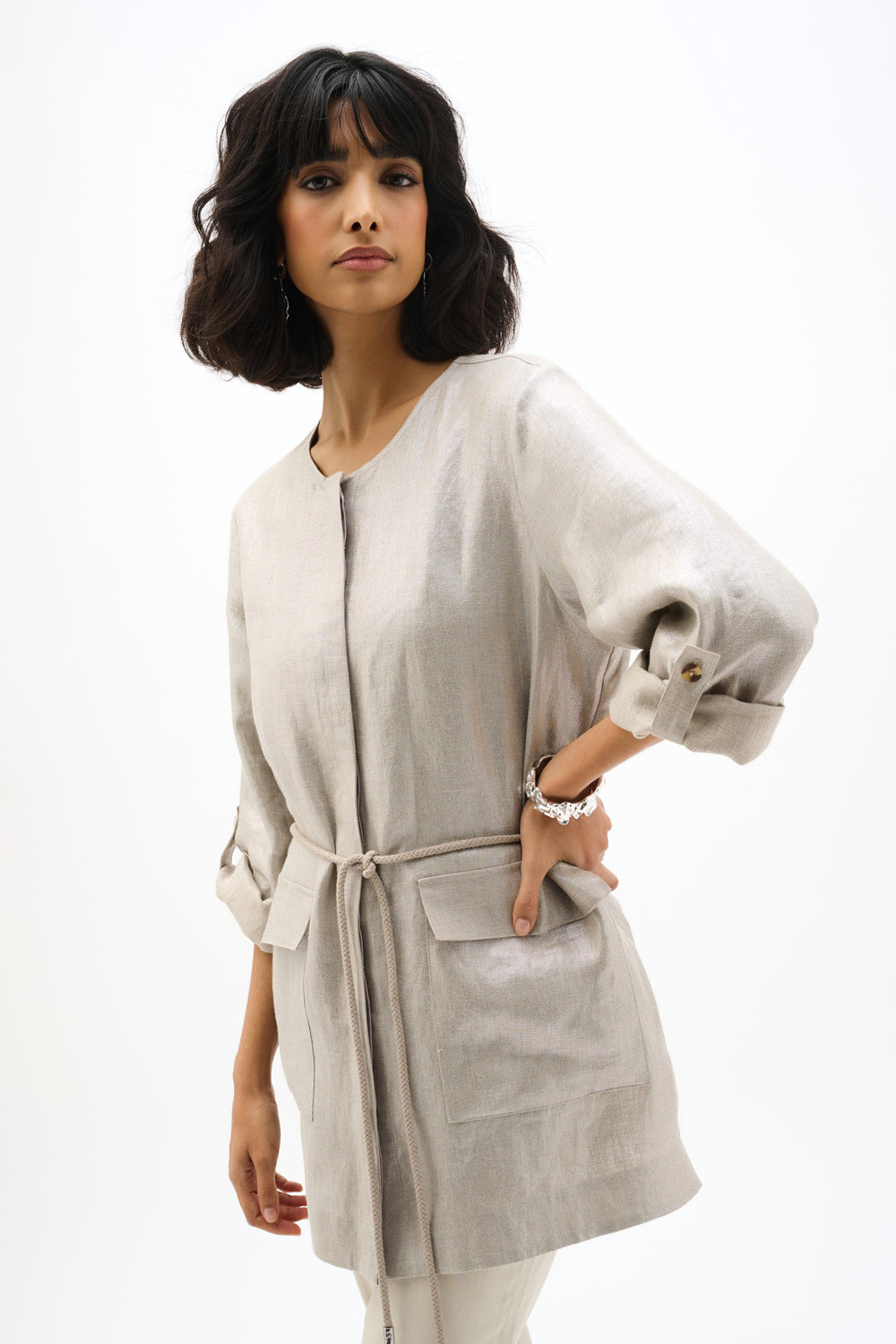 Woman wearing a light gray kimono-style jacket on a white background