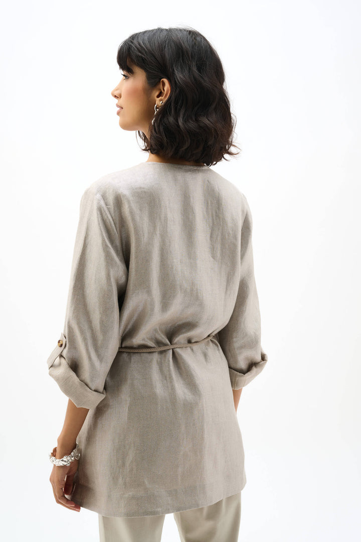 Woman wearing a light beige jacket on a white background