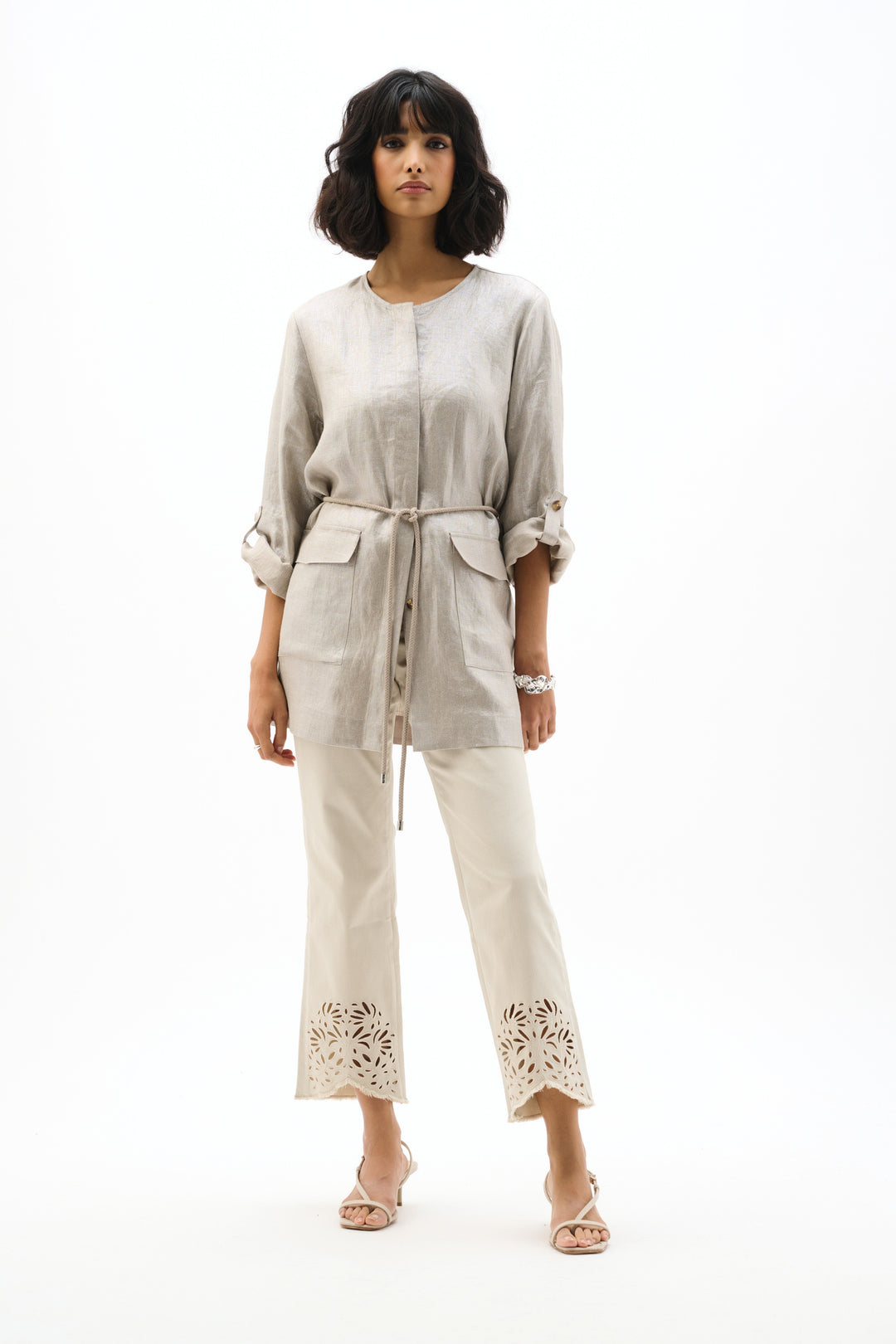 Woman wearing a beige outfit on a white background