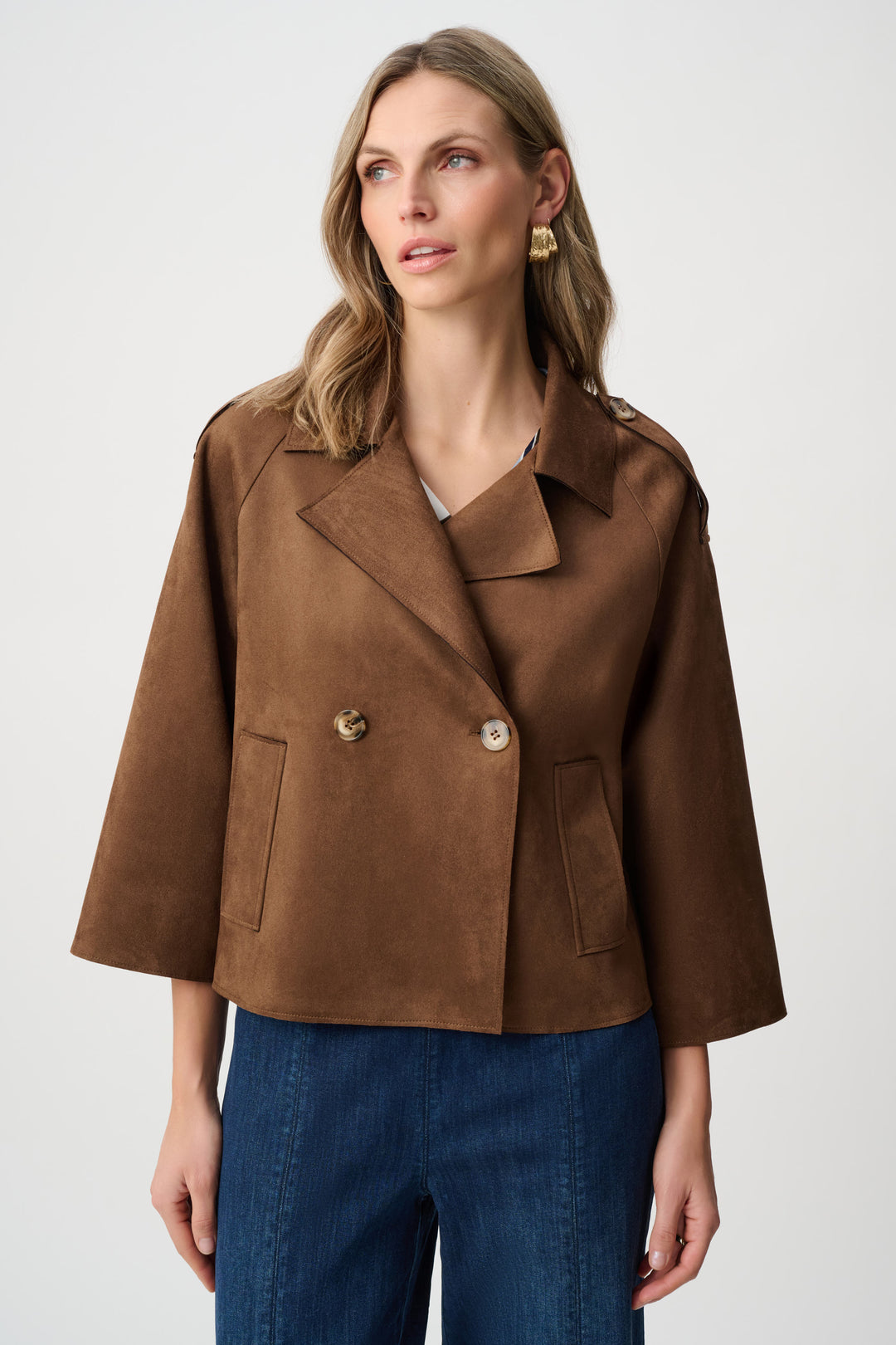 Woman wearing a brown light jacket with notch collar with a white background