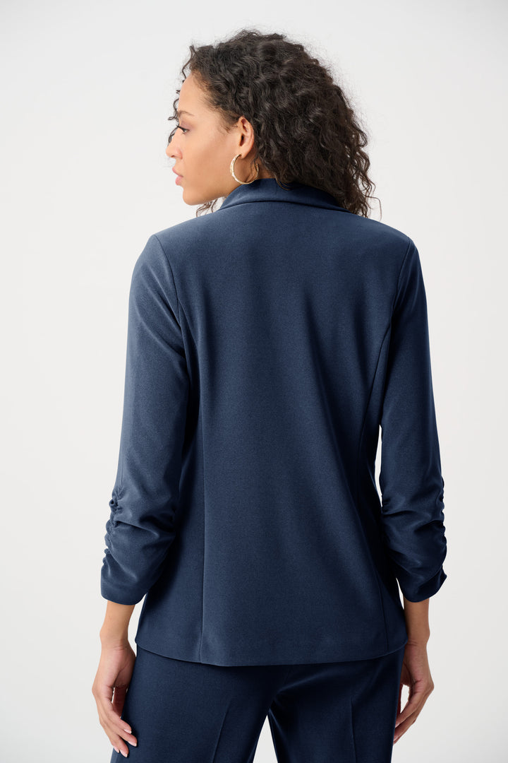 Person wearing a navy blue long-sleeve top on a white background