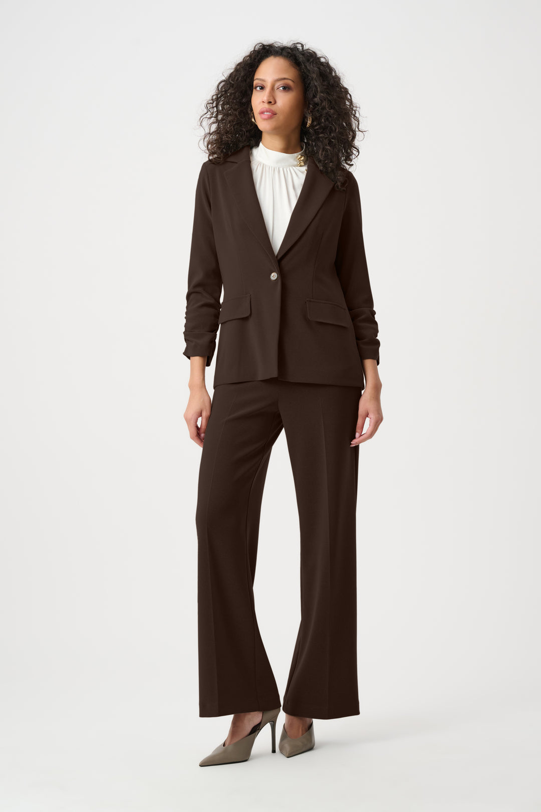 Woman wearing a brown suit on a white background