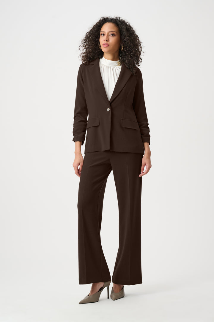 Woman wearing a brown suit on a white background