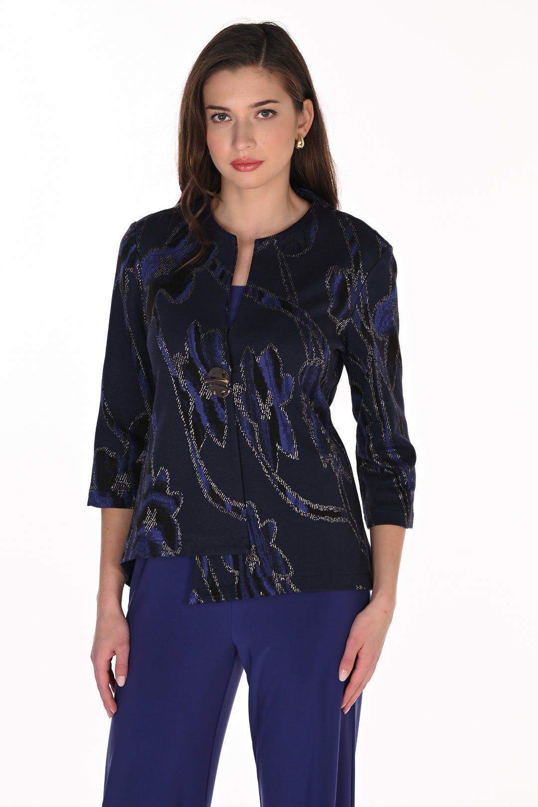 A woman modeling a dark navy blue three-quarter sleeve top with metallic gold floral embroidery and a split neckline, paired with royal blue pants, against a plain white background.