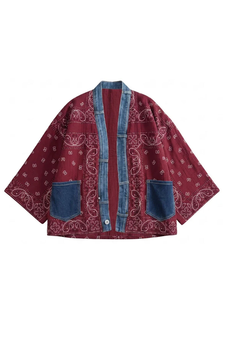 A bohemian-style open-front jacket featuring a maroon bandana paisley print, blue denim trim, and two large blue denim front pockets, shown flat on a white background.
