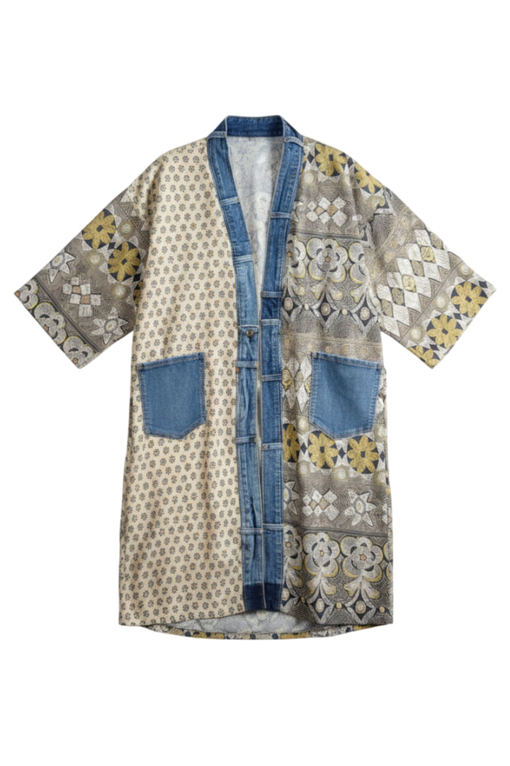 A short-sleeved open-front kimono-style cardigan featuring a mixed pattern of beige geometric prints, blue denim-like trim and pockets, and yellow floral accents, shown against a plain white background.