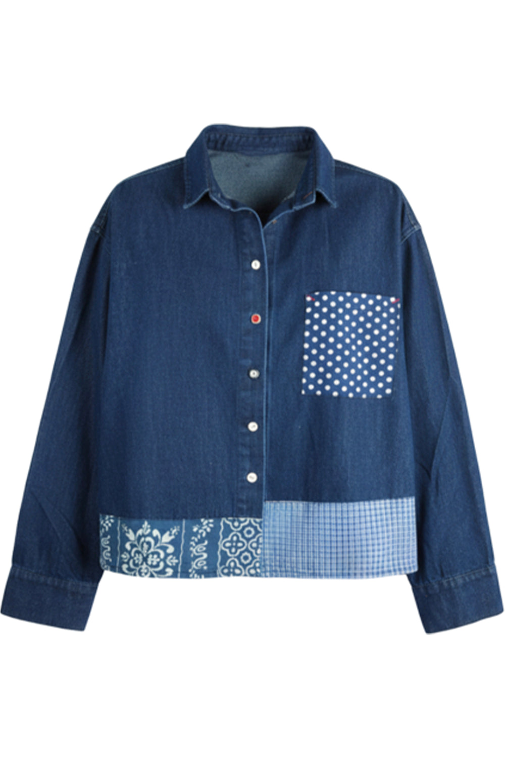 A blue denim patchwork button-up shirt with a patterned chest pocket and a decorative band of gingham, polka dots, and paisley at the hem, shown on a plain white background.