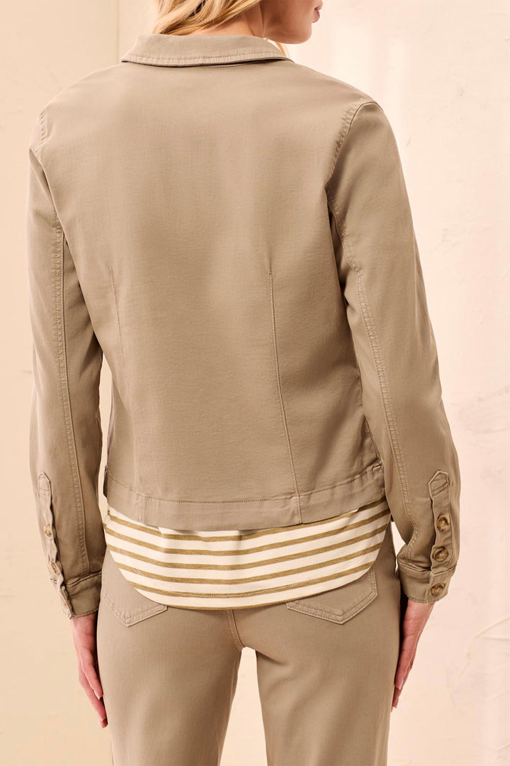 A woman shown from the back wearing a cropped tan utility jacket over a cream and tan striped shirt, paired with matching tan pants, against a light beige background.