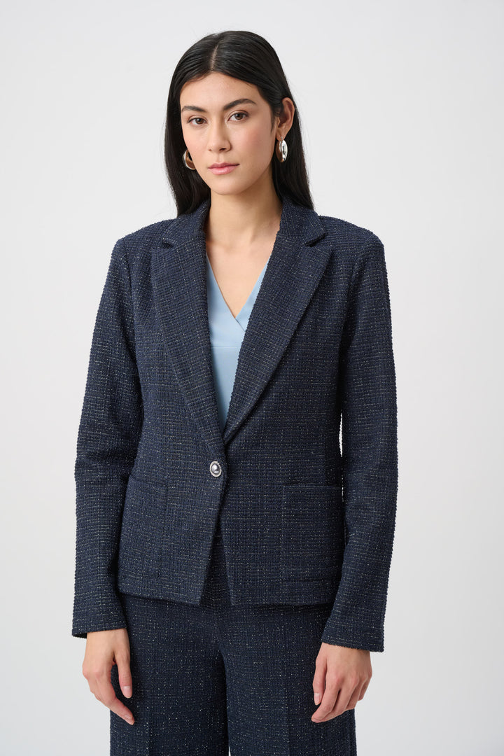 Woman wearing a navy checkered blazer and pants on a white background