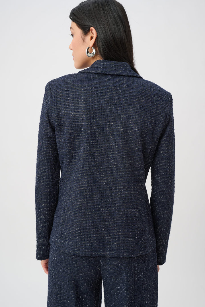 Person wearing a navy blue checkered suit on a white background