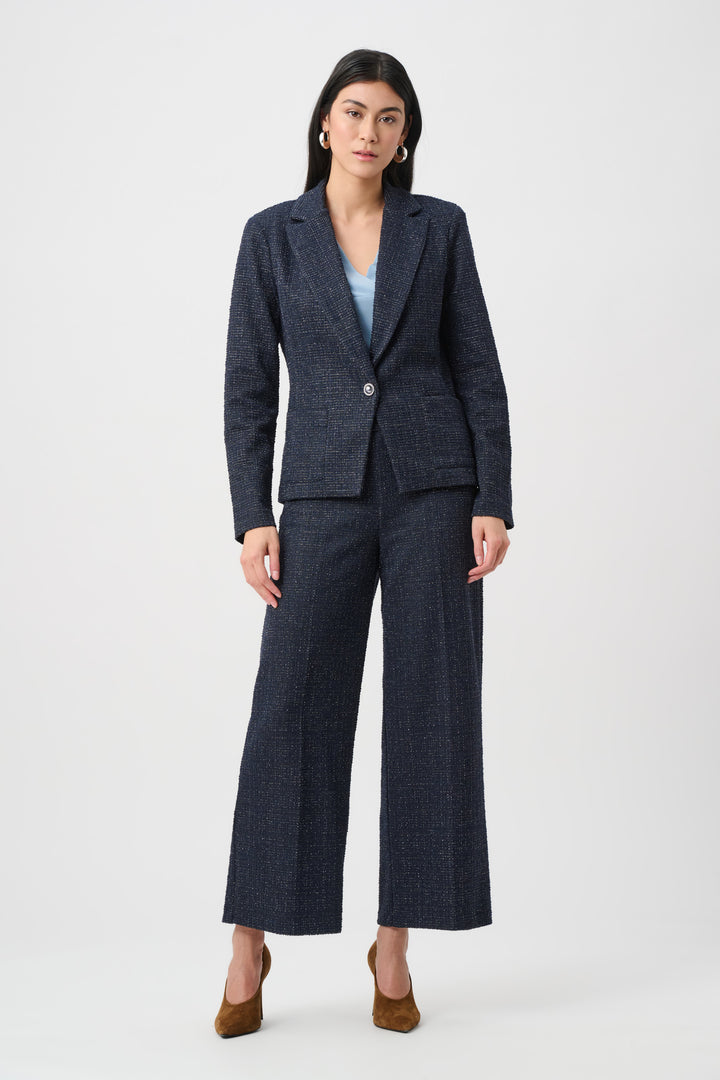 Woman wearing a dark blue suit on a white background