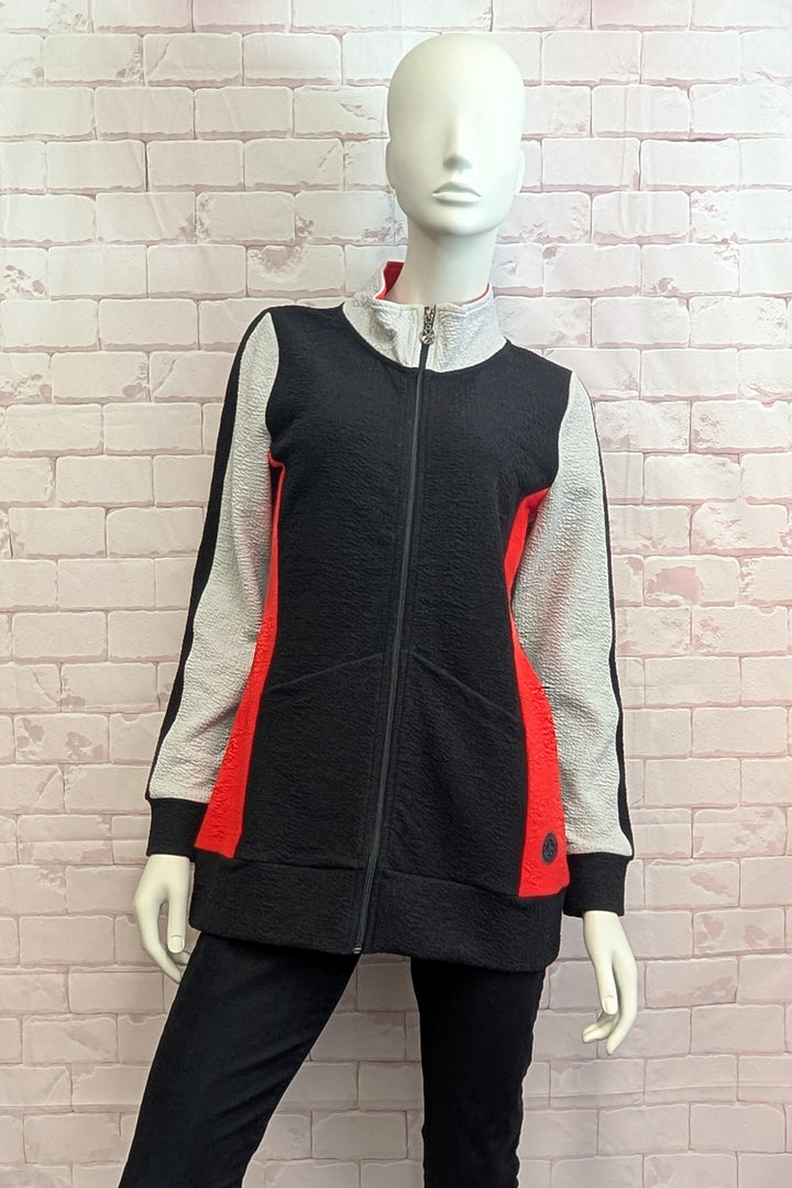 A black, gray, and red color-blocked zip-up jacket displayed on a white mannequin against a light pink brick wall background.