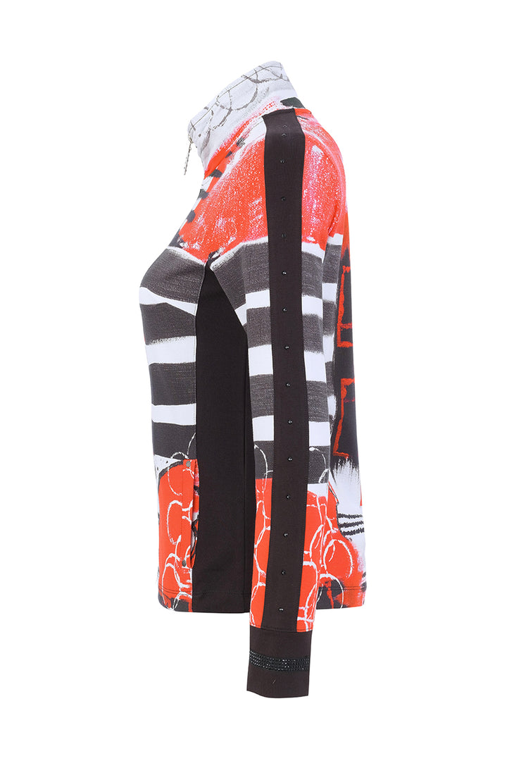 A long-sleeve knit top with a bold abstract pattern in orange, black, white, and gray, featuring a high collar and a single button on the sleeve cuff, shown from a side profile view against a white background.