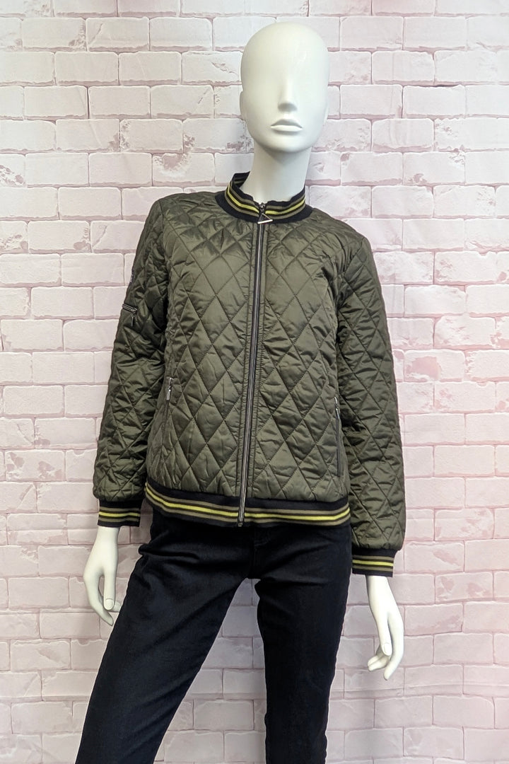 A mannequin wearing an olive green diamond-quilted bomber jacket with black and lime green striped ribbing on the collar, cuffs, and hem