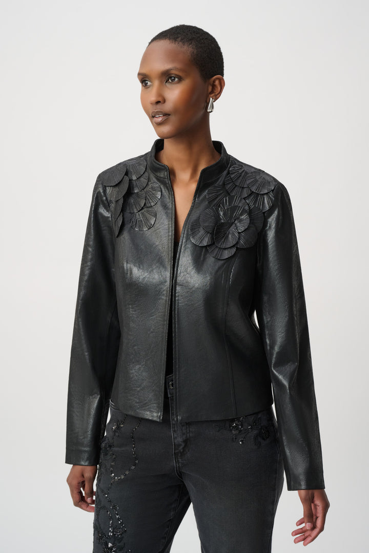 Woman wearing a black leather jacket with floral embellishments on a white background